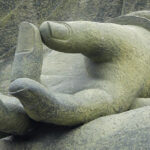 An image of a mudra (hand gesture) depicting the thumb touching the tip of the ring finger.